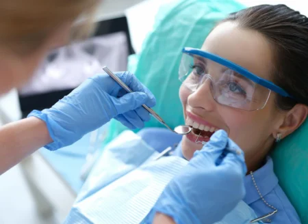 doctor-examining-oral-cavity-female-patient-using-dental-instruments-clinic_151013-32051